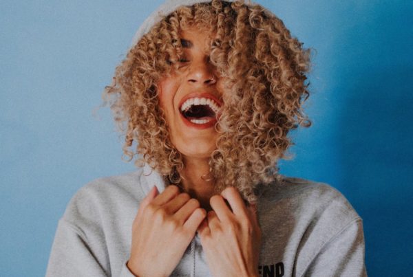 Person in hoodie laughing