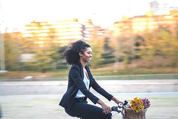 Business woman riding a vintage bicycle in the city