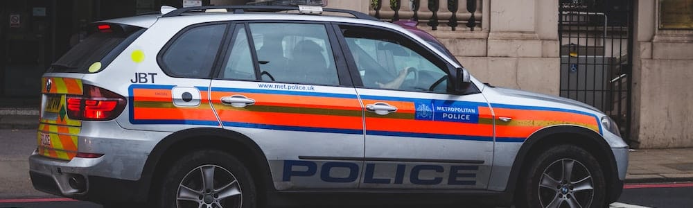 Police car driving along a road