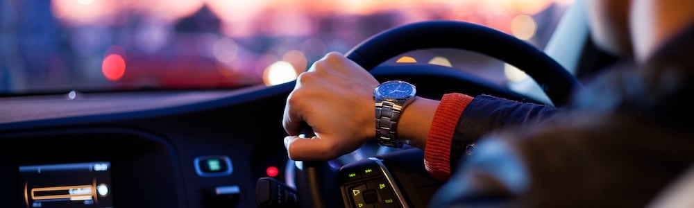 A hand on a steering wheel