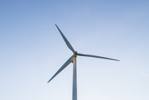 Wind turbine against a pale blue sky