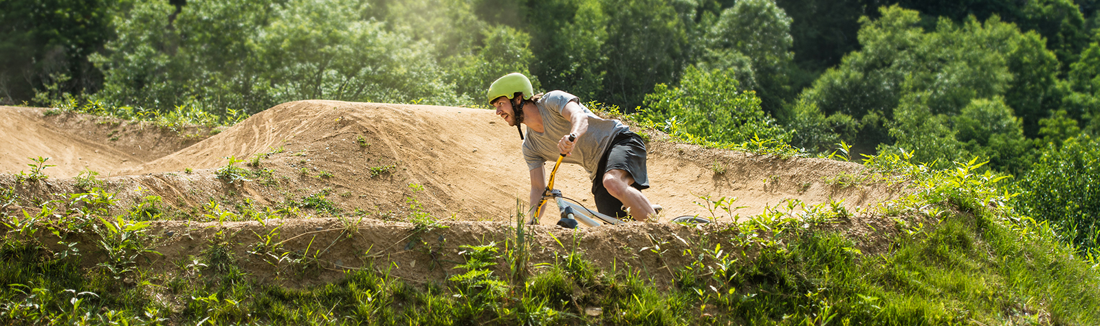 Mountain biker speeding around bend on downhill track. He used temporary car insurance to get to his starting point that day