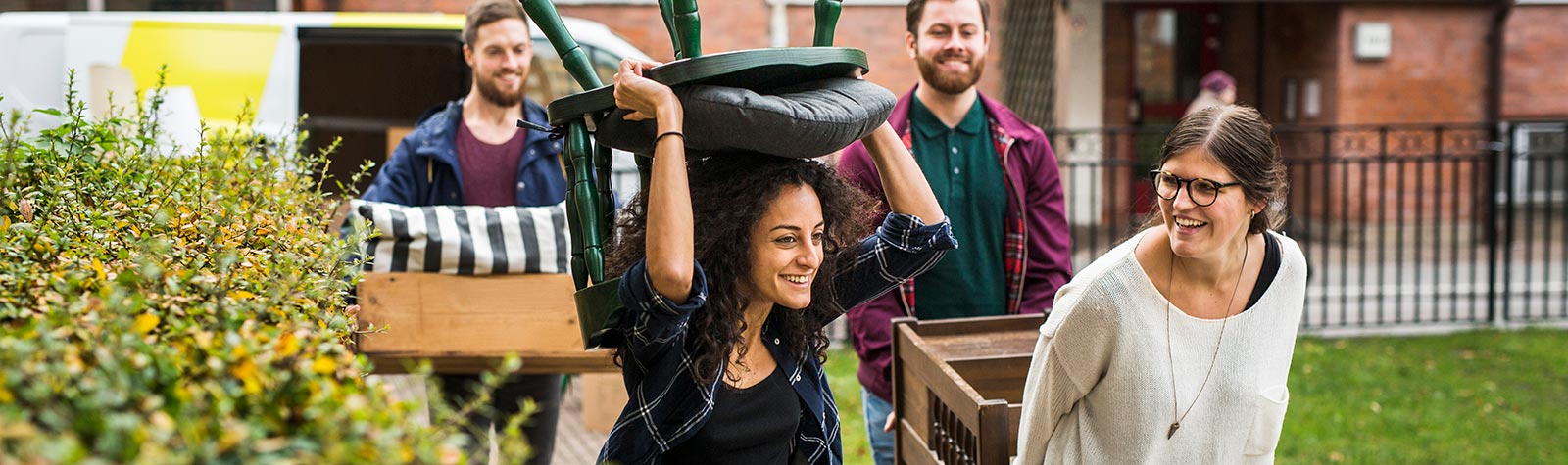 Group of friends moving furniture to van insured with temp cover